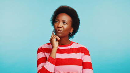 Thinking, studio and face of black woman with doubt for choice, decision and options. Question,...