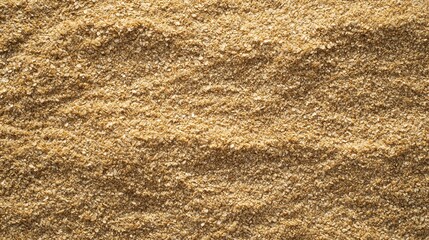 Brown sugar granules create a warm, inviting texture on a kitchen surface. The golden hue reflects light, emphasizing their fine, granular quality, perfect for baking