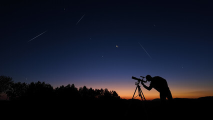 Amateur astronomer looking at the evening skies, observing planets, stars, Moon and other celestial...