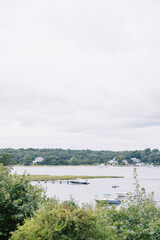 vertical landscape greenery and boats in harbor on Cape Cod