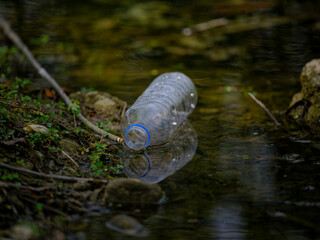 plastic water bottle by the river