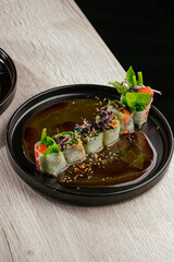 spring rolls with salmon, herbs and sesame
