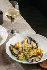 spaghetti with shrimps mussels and a glass of wine