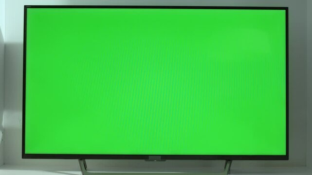 Large modern television with green chromakey