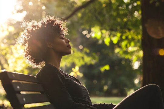 A person sits on a park bench, eyes closed, feeling the morning breeze. Soft whispers of affirmations fill the quiet space around them