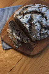 Homemade  buckwheat bread  with some slices on a wooden cutitng board on a table