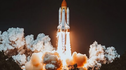 The space shuttle is launching into the dark night sky