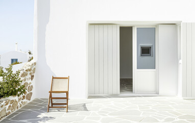 Elegant minimalist architecture with a simple wooden chair in a bright outdoor space