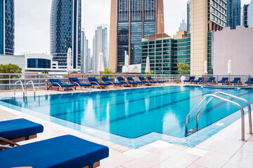 Dubai. Rooftop pool surrounded by city views in Dubai, perfect for vacation and leisure.