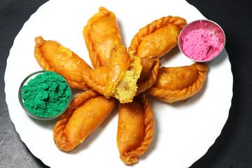 Gujiya or gujia is a popular North Indian sweet of flaky pastries with khoya, nuts stuffing.