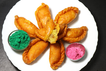 Gujiya or gujia is a popular North Indian sweet of flaky pastries with khoya, nuts stuffing.