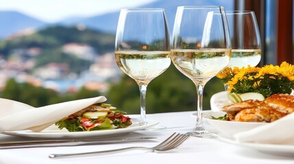 Elegant Dining Table Setup with White Wine, Fresh Salad, and Grilled Chicken Against Scenic View