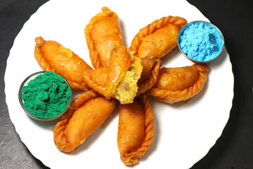 Gujiya or gujia is a popular North Indian sweet of flaky pastries with khoya, nuts stuffing.