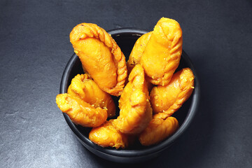 Gujiya or gujia is a popular North Indian sweet of flaky pastries with khoya, nuts stuffing.