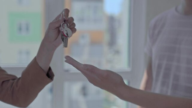 A close-up of the keys being handed over to the new apartment owner
