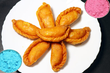 Gujiya or gujia is a popular North Indian sweet of flaky pastries with khoya, nuts stuffing.
