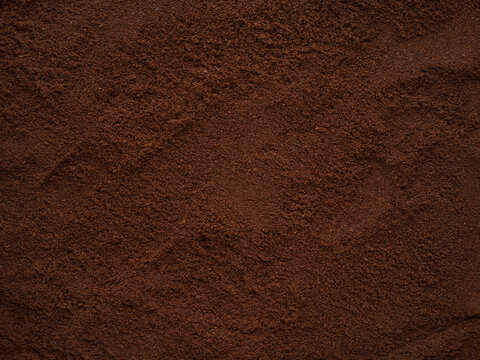 Grounded coffee beans top view background texture