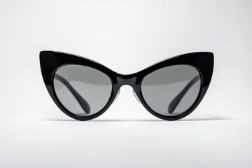 Fototapeta premium Oversized black cat-eye sunglasses with glossy frames and dark lenses, isolated on white background