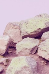 Obraz premium Jagged rock formation with mossy texture against soft earth tone background