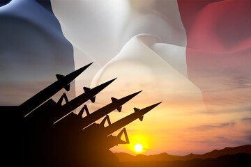 Silhouette of missiles against the sunset with flag of France. Nuclear missiles concept