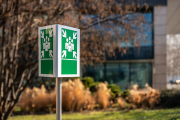 Emergency assembly point sign outdoors with text placeholder