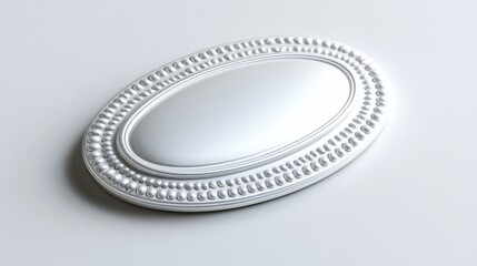 Oval-shaped, decorative piece. Bordered with raised dots. White background