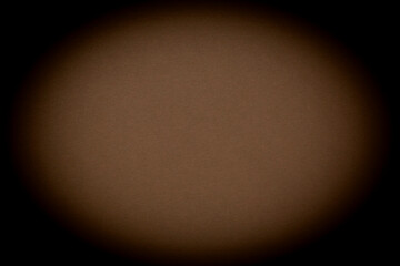 close up of coffee color cardboard illuminated in form of coffee bean