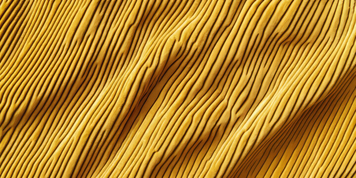 A high-resolution corduroy fabric texture background in warm mustard yellow. The parallel ridges, or wales, add depth and texture, making it ideal for vintage fashion, upholstery, and autumn-inspired