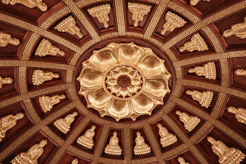 Intricate golden ceiling design featuring multiple Buddha figures in Ninh Binh, Vietnam, showcasing traditional craftsmanship and culture