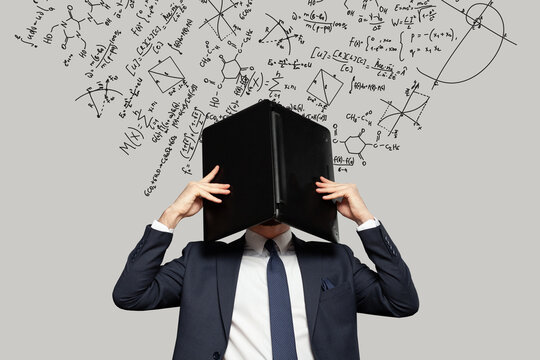 Frustrated stressed businessman hiding his head under laptop in office with mathematical formulas on the background. Concept of money, education and enterpreneurship - Powered by Adobe