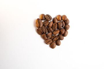 heart shaped roasted coffee beans on white background Top view Flat lay Creative concept
