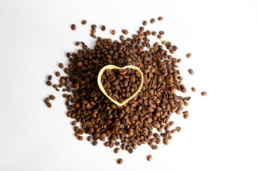 Coffee beans in a small heart shape bowl. Concept for commercial product