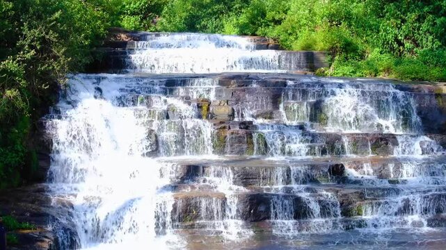 Scenic view of Nanu Oya waterfalls in Nanuoya, Nuwara Eliya district of Sri Lanka with free flowing, cascading water over rocks