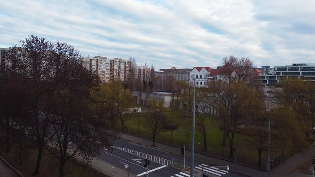 Aerial establishing of Budapest streets with moving traffic and urban buildings on an overcast day near RaM ArT Szinhaz