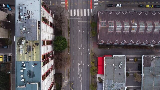 Aerial top down of an intersection in Budapest, Hungary, cars and pedestrians moving, slow pan