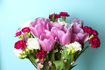 Beautiful bouquet of fresh flowers on a color background