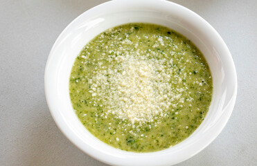 vibrant green spring soup made with fresh leek, spinach, and beans, served in a bowl