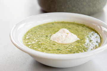 vibrant green spring soup made with fresh leek, spinach, and beans, served in a bowl