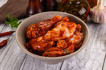 Raw marinated buffalo chicken wings