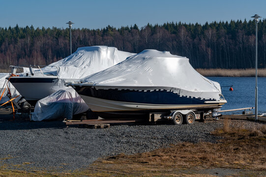 Two motor boats with plastic cover for winter storage