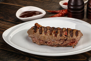 Grilled beef striploin steak with sauce