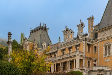 Historic building with ornate architecture, featuring intricate stonework, tall chimneys, and slate...