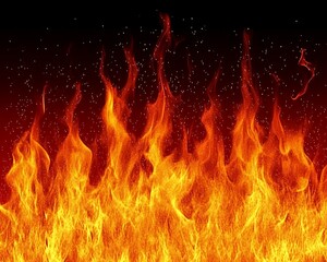 A close up view of burning flames with embers and darkness