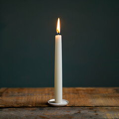Elegant Still Life of a Single Tall White Taper Candle with a Bright Flame on a Clean White Background
