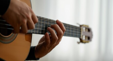 Close-up of hands playing acoustic guitar, indoors, soft lighting