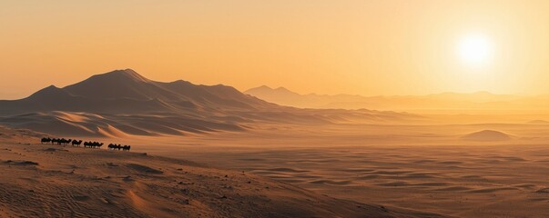 Naklejka premium Camel caravan crossing the vast desert dunes at golden sunset