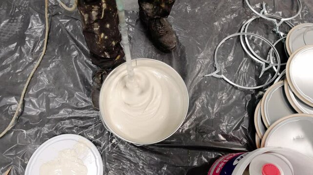 Construction worker mixing epoxy resin and hardener