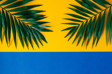 Green palm leaves on a bold yellow background create a vibrant. Tropical and minimalist contrast.