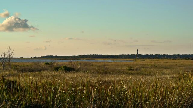 Rising 165 feet and painted with striking black and white stripes, picture-perfect Bodie Island Lighthouse at sunset.