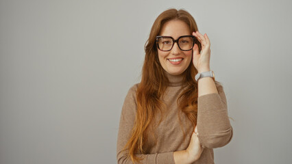 Woman smiling confidently redhead wearing glasses stands isolated white background exhibiting...